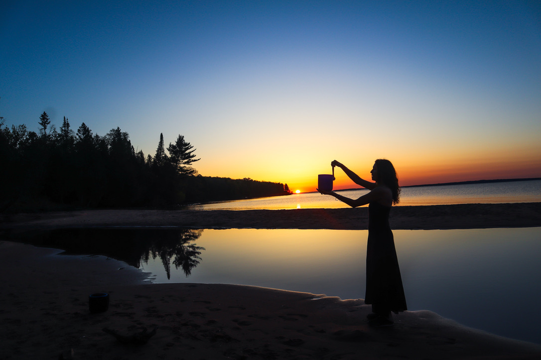 woman on beach with sound bowl